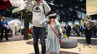 ein Mann und ein Kind tragen VR-Brillen
