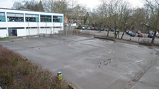 Asphaltierter Schulhof und Gebäude der Martinus-Schule in Meerbusch