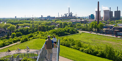 Panoramic view of an industrial area with cyclists and pedestrians