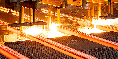 A machine processes highly heated steel