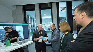 Mehrere Personen schauen sich eine Vorführung an