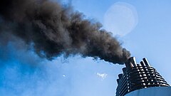 Smoking chimney against a blue sky