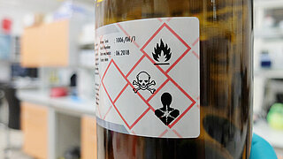 Chemical bottle with hazardous substance labels